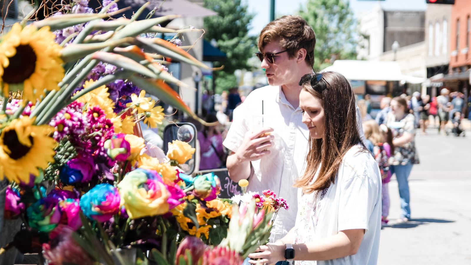 A couple with flowers at Arts in Bloom